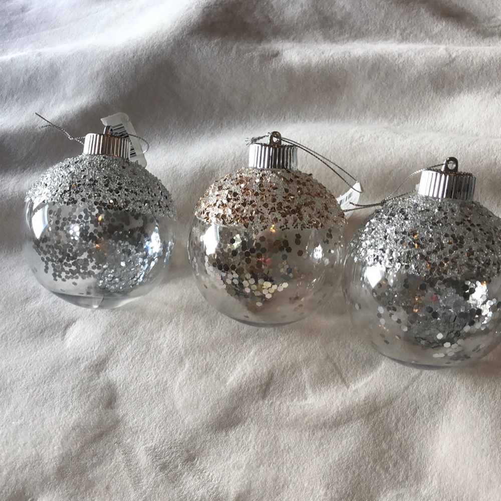 3 Kirkland Christmas tree bulbs. 2 silver and 1 gold. Clear plastic.